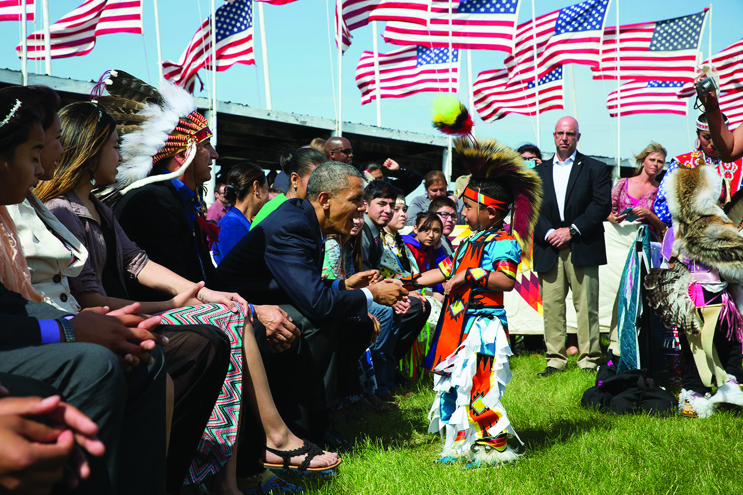 President Obama greets a young Native American child participating in an event