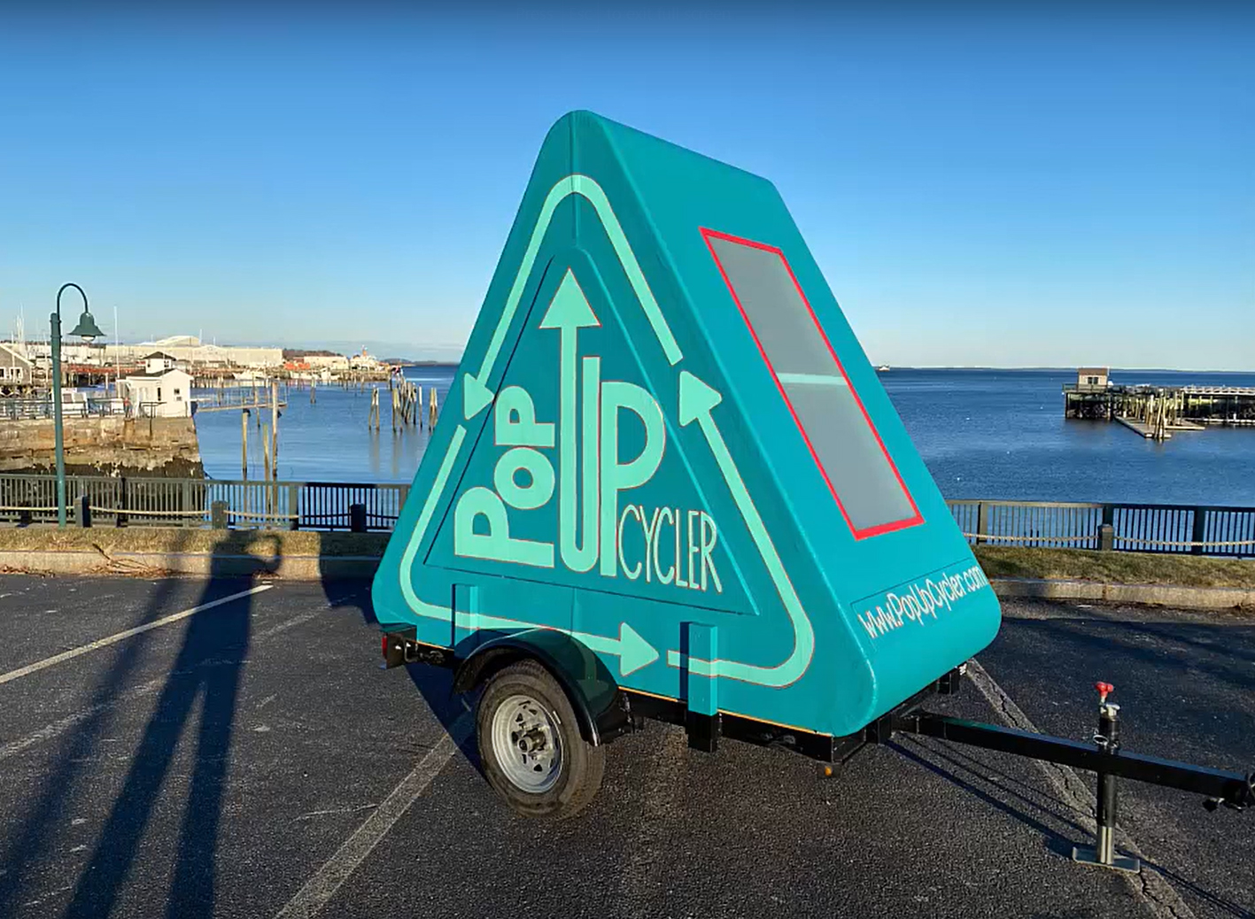 A triangular trailer on wheels that says Pop Up Cycler.