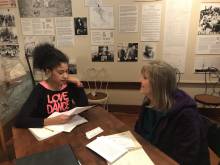 A student interviews a community resident at a local museum A student interviews a community resident at a local museum