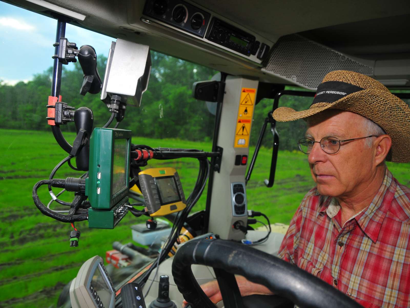 Farmer using technology in tractor