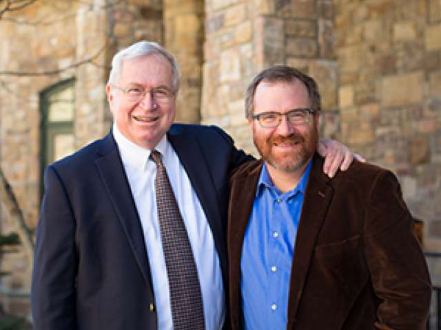 John and Andrew Payne, father and son, stand side by side. 