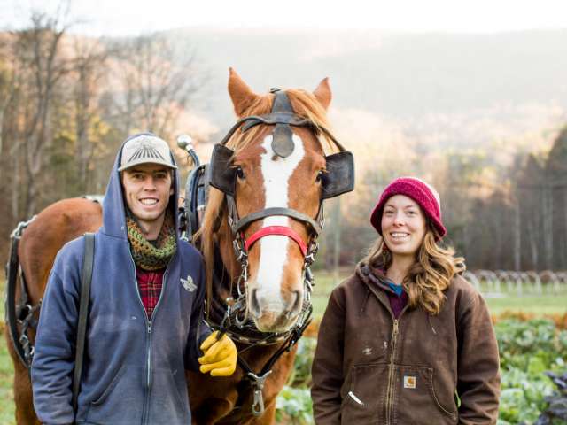 Jacob Crigler and Kara Dodson pose with a horse on their farm. 