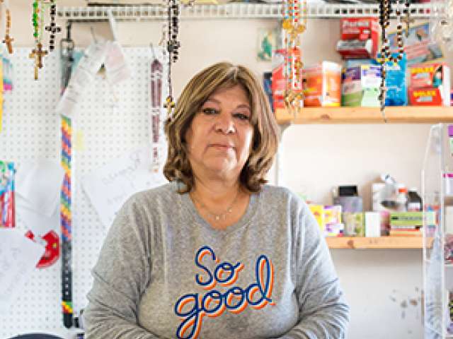 Maria stands inside her store. 