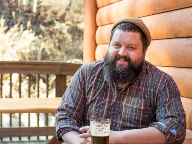 Seth Sullivan outdoors with a beer. 