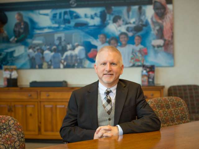 Terry Harmon, wearing a suit. 