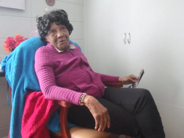Eugenia Powell Deas sits in her chair.