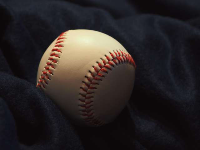 A white baseball is wrapped in a blue jacket. Pexels stock photo. 