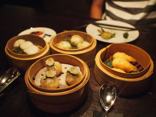 An arrangement of dumplings and wontons in bamboo bowls. Pixabay