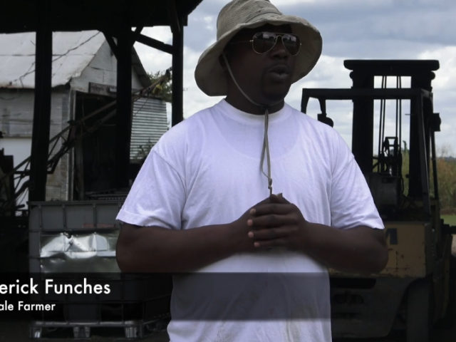 Wearing a straw hat and white t-shirt, Roderick Funches discusses farming in the Delta.