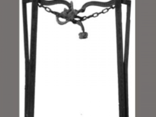 A forked metal object with a chain around the top. 