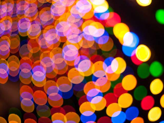 Colorful blurred lights sparkle on a holiday tree. Pexels photo