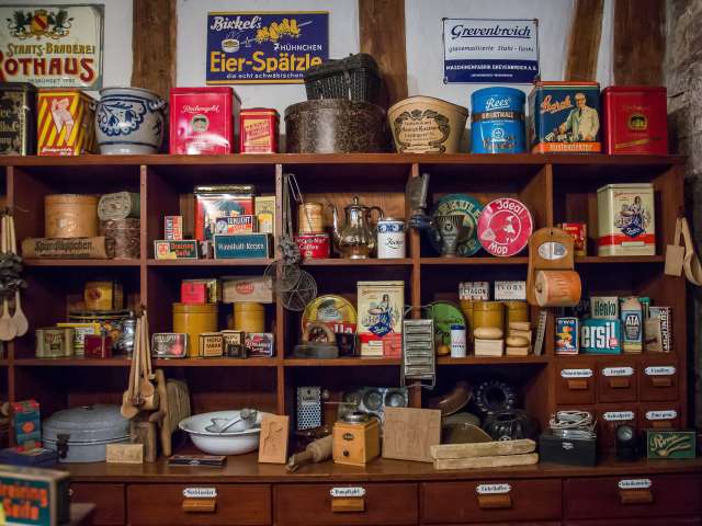 The shelves of a vintage store, stocked with unusal goods. 