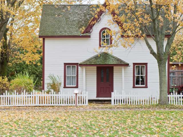 A small, quaint house in the country during autumn. 