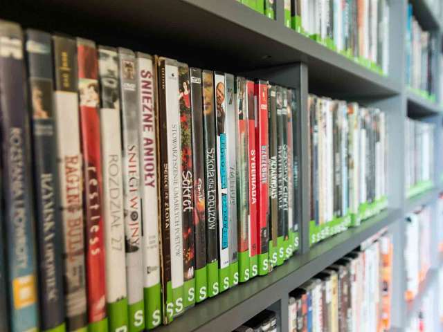 A shelf with dozens of DVDs.