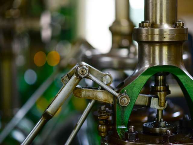 Close-up view of metal machine parts in a factory setting. 