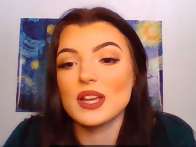 Madison has long, straight dark hair and bright, red lipstick. She sits in front of a print of Starry Night by Van Gogh.
