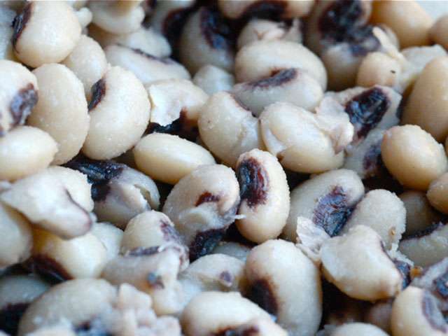 A close-up view of raw black-eyed peas. 