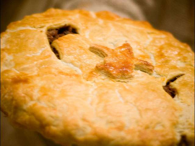 A close-up view of the delicious flaky crust of a pie.
