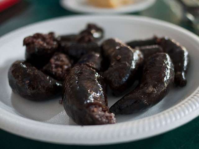 A white plate with Polish blood sausages. 