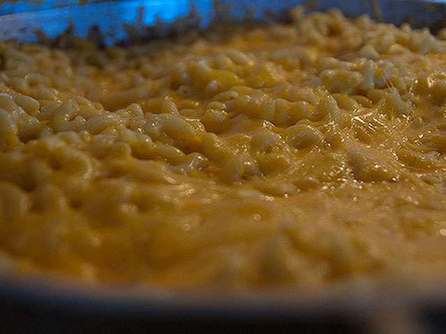 A view of the top of bowl of macaroni and cheese.