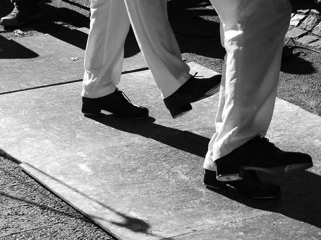 A black-and-white image of dancing feet. 