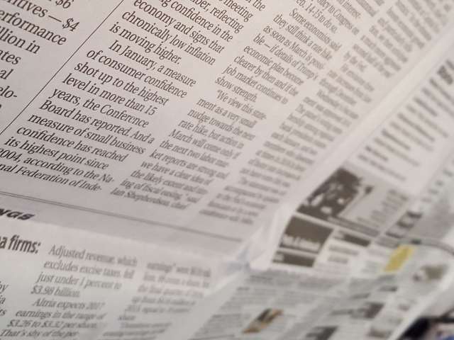 A close-up view of an open newspaper.