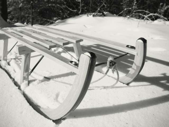 Old-fashioned sled in black-and-white photograph