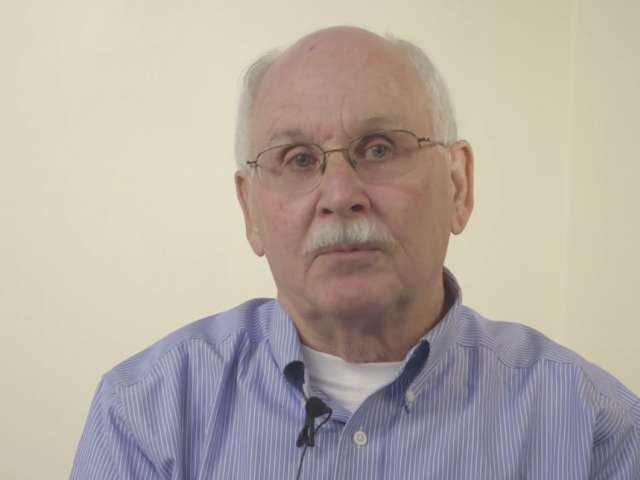 Don Lewis of Maryland wears a blue shirt and has a white mustache. 