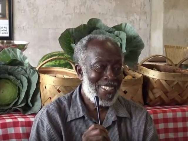 Local farmer John Cousar beside his vegetable table.