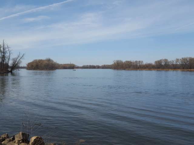 View of a placid lake from the shore. Courtesy Minnesota Humanities Center
