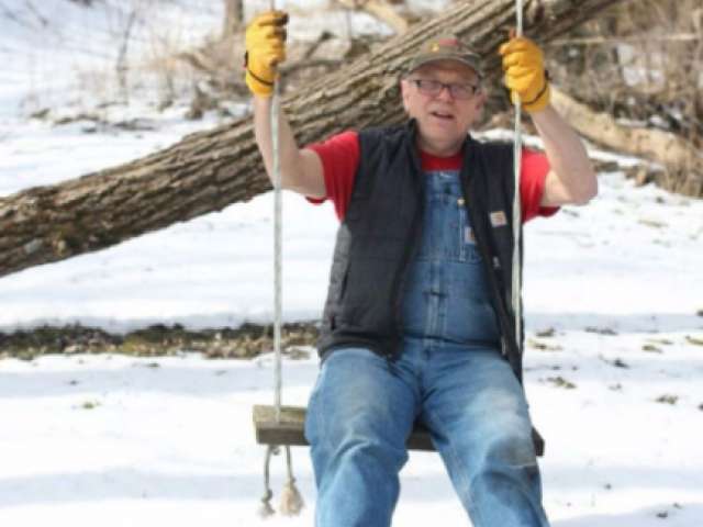 Frank Wright on a swing in snowy Minnesota.