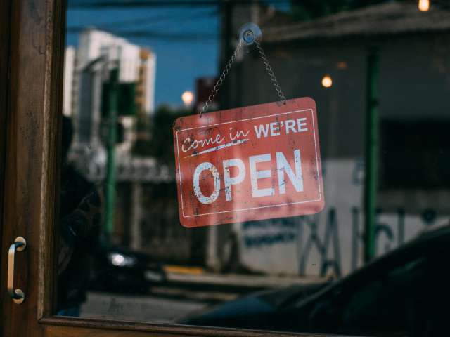 A red open sign in a store window. Pexels stock photo