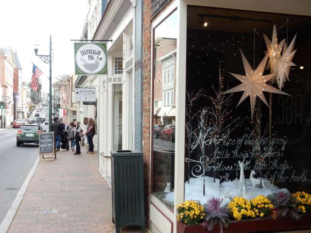 The sidewalk in a small town, featuring story fronts and windows. Photo by Heather Shelton