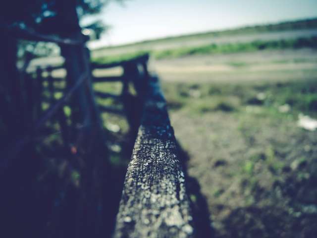 A blurred image of a vintage fence railing on a farm. Pexels stock photo. 