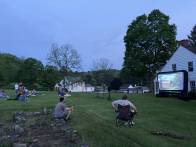 Community members watch student films in Arthurdale.